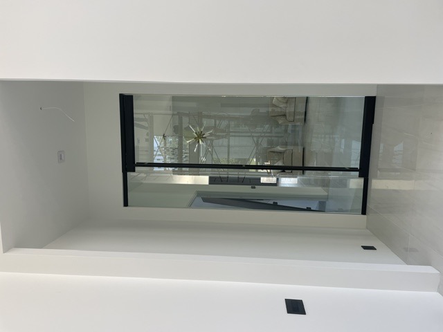 Black-trimmed interior glass sliding door in a modern hallway by West Little Rock Glass