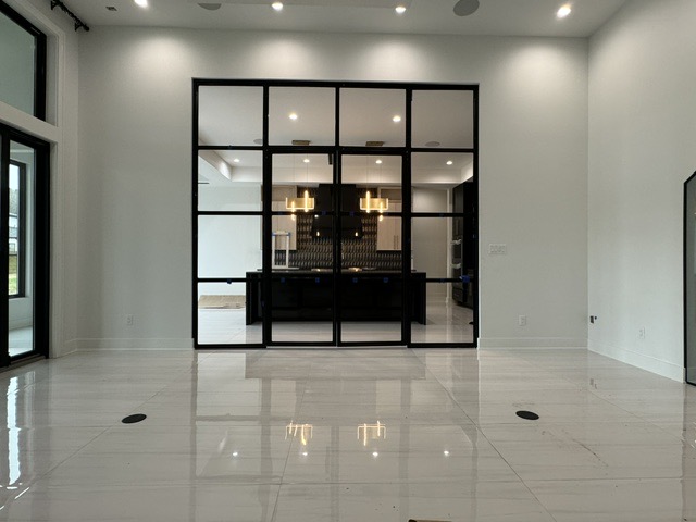 Black grid-framed interior glass partition wall by West Little Rock Glass, the kind of project we take on in Bentonville