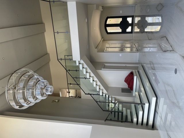 Glass balcony and stair railing in a grand foyer by West Little Rock Glass, serving North Little Rock