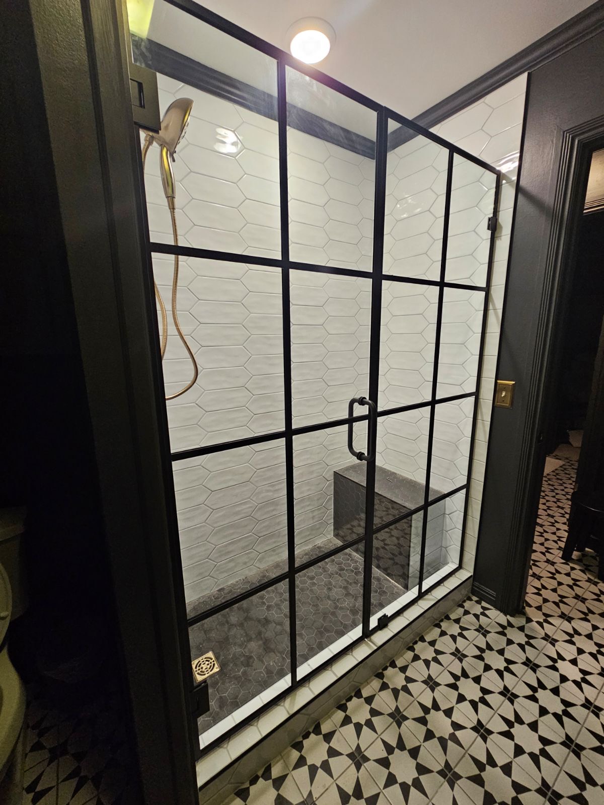 Black grid-framed glass shower door over picket tile by West Little Rock Glass, serving Sherwood